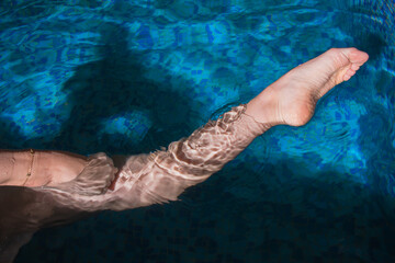 Pointed Feet and leg of Synchronized Swimmer in a Pool