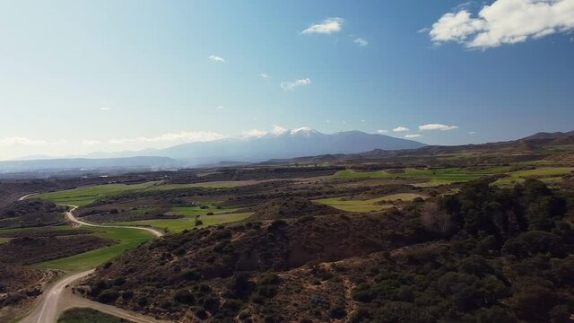 Drone aerial view in Spain across countryside turning right close to  Moncayo snow mountain landscape