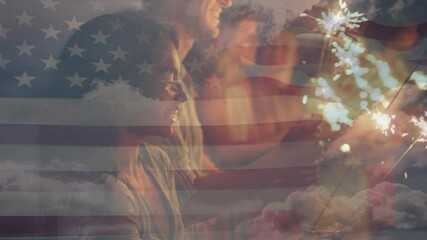 Animation of american flag waving over group of friends holding sparklers on beach - Powered by Adobe