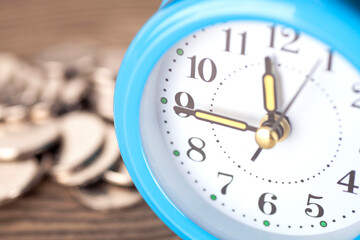 Close up of alarm dial and fuzzy coin background