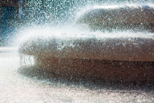 Dense water splashing of fountain in the sunlight