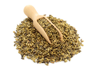 A Heap of Milk Thistle Seed with Scoop Isolated on White. Also Known as Silybum Marianum, Cardus Marianus, Blessed Milkthistle, Marian, Mary, Saint Mary's, Mediterranean, Variegated or Scotch Thistle