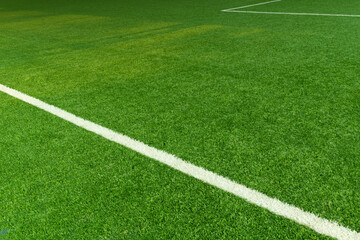 green artificial grass football field with white line