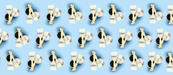 Many cans of paints with brushes on color background