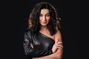 Portrait of beautiful young woman on dark background