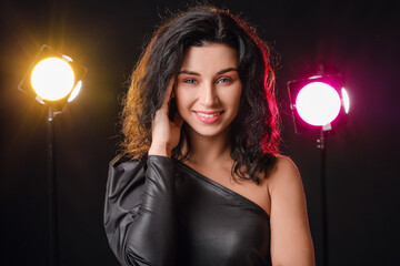 Portrait of beautiful young woman on dark background