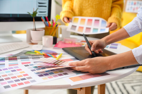 Graphic designer with colleague working in office