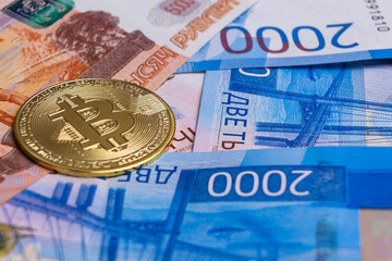 golden bitcoin lies on Russian banknotes