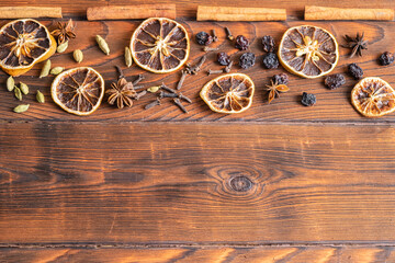 Christmas spices on a wooden background from above. at the bottom there is a place for an inscription