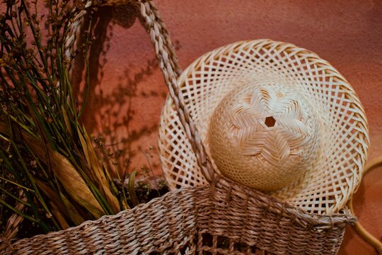 Close-up Of Bamboo Weaving Hat Hanging On Wall And Basket