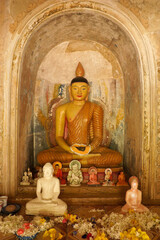 Buddha image and offerings at Gangarama Mahavihara Buddhist temple, Hikkaduwa, Sri Lanka