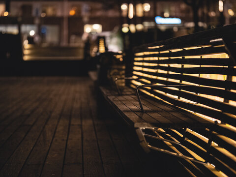 Empty Bench On Footpath In City At Night