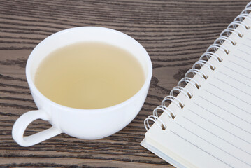 A cup of tea and a notebook
