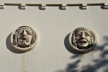 Plaster masks on wall of the theater