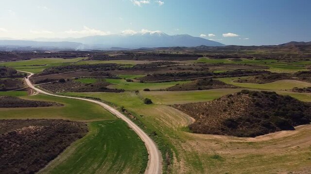 Drone aerial view in Spain across countryside turning left close to  Moncayo snow mountain landscape