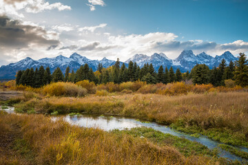 dramatic snowcapped  mountain landscape in the Grand Tetons National Park in Wyoming.