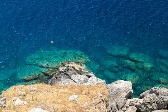 View From The Acropolis On The Rocky Coast With Blue And Turquoise Water In Lindos On Rhodes Island