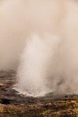 dramatic photo of bubbling and steaming hot spring in the Yellowstone National park in Wyoming.