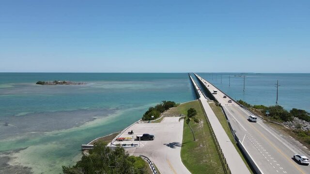 Drone flight north up U.S. highway 1 near Little Money Key looking at Seven Mile Bridge.  A public boat ramp called the Little Duck Key Wayside Park Public Boat Ramp is clearly visible below