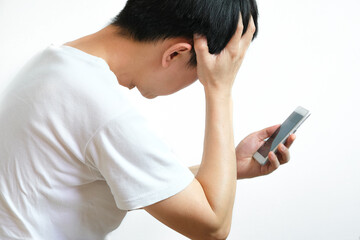 Young caucasian man angry, frustrated and furious with his phone, angry with customer service White...