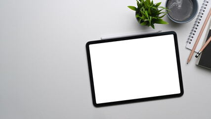 Above view of mock up digital tablet with empty screen on white background.