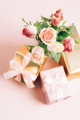 Beautiful fresh roses festive gift box on pastel pink background. Copy space
