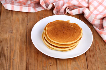 Pancakes on wooden background