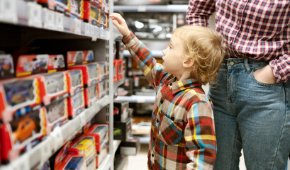 A child chooses toys in a toys market