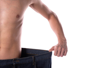 Funny young guy in big pants. Diet and weight loss. The result of fitness and training. White background. Isolate.