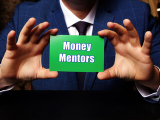 A handsome businessman showing a blank piece of paper with sign Money Mentors .