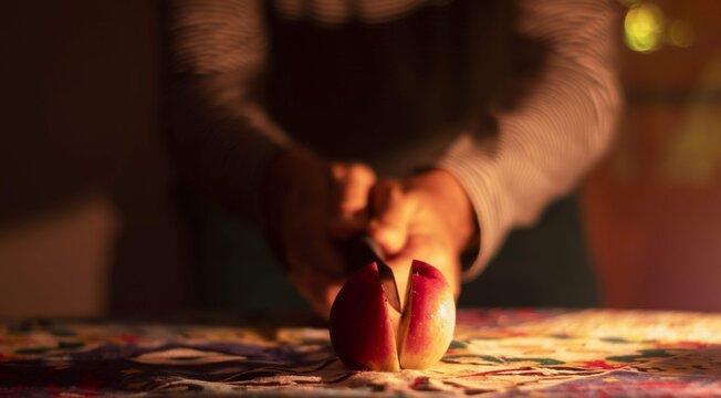 Cropped Image Of Hand Holding Apple