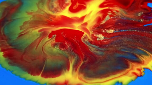 Colorful background in yellow, blue and red paint flow on universe colors surface mix patterns. macro