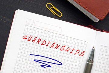 Business concept meaning GUARDIANSHIPS with phrase on the piece of paper. Guardianship is a legal...