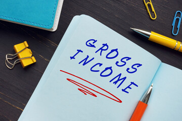 Financial concept about GROSS INCOME with sign on the sheet. Gross income represents the total income from all sources, including returns, discounts, and allowances