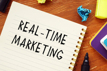 Business concept meaning REAL-TIME MARKETING question marks with inscription on the page.