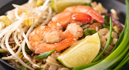 Pad Thai with shrimp on a stone background, selective focus, close-up