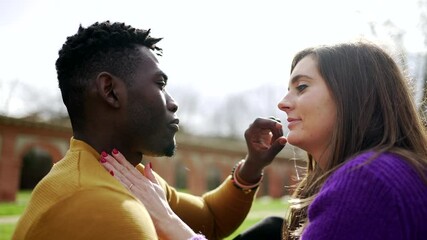 Young interracial couple kiss. Millennial lovers, African and white couple