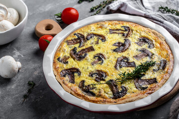 Homemade quiche lorraine with mushrooms, cheese and thyme. Tart with Mushroom pie. French cuisine. top view. French cuisine