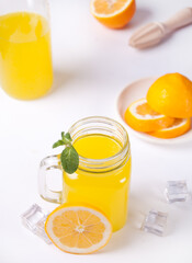 Jar of fresh lemonade. Sliced lemon on background.