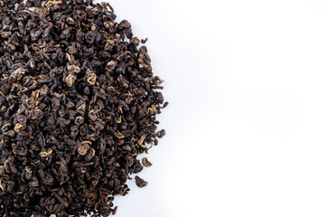 Heap of black tea on a white background. Dry black tea leaves isolated on white background, delicious, natural. Flat lay.