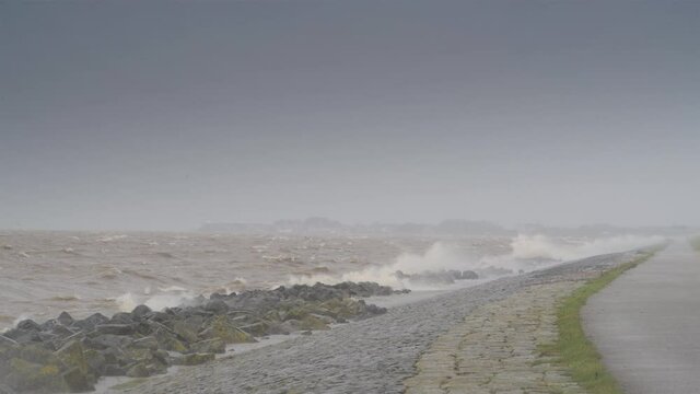 Waves on the IJsselmeer hitting the levee of the Noordoostpolder during an early springtime storm