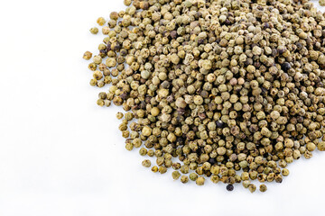 Green peppercorns. Heap of tea on a white background. Close up. A high resolution. Dry bunch of green peppercorns, peppercorns isolated on white. Spice jar.