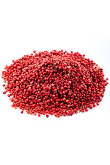 Spice. Pink pepper. Heap of pink peppercorns on a white background. Spicy spice.