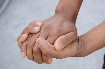 joint hands mental awareness health concept on the grey background.