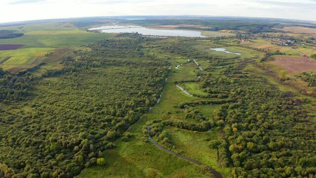 4k drone forward video (Ultra High Definition) of Seret river. Beautiful morning scene of Ternopil countryside, Ukraine, Europe. View from flying drone of green valley.