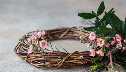 Decorative spring wreath made of twigs and flowers. DIY creativity.