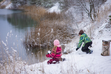 Fototapeta na wymiar children walking in winter nature, selective focus