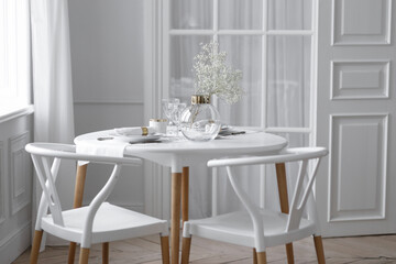 White loft interior in a Scandinavian style with a table. Set wooden table in a bright interior, photo studio.