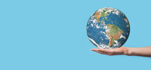 3D Earth planet globe in man, woman hand, hands on blue background. Environmental protection concept. Elements of this image furnished by NASA