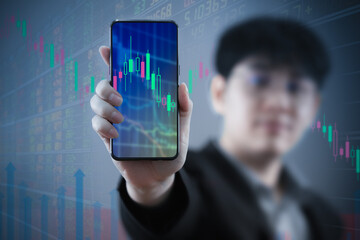 Investor and trader concept - investor with Smart phone and tradeview graph and marketting reports on Smart phone screens in his modern.